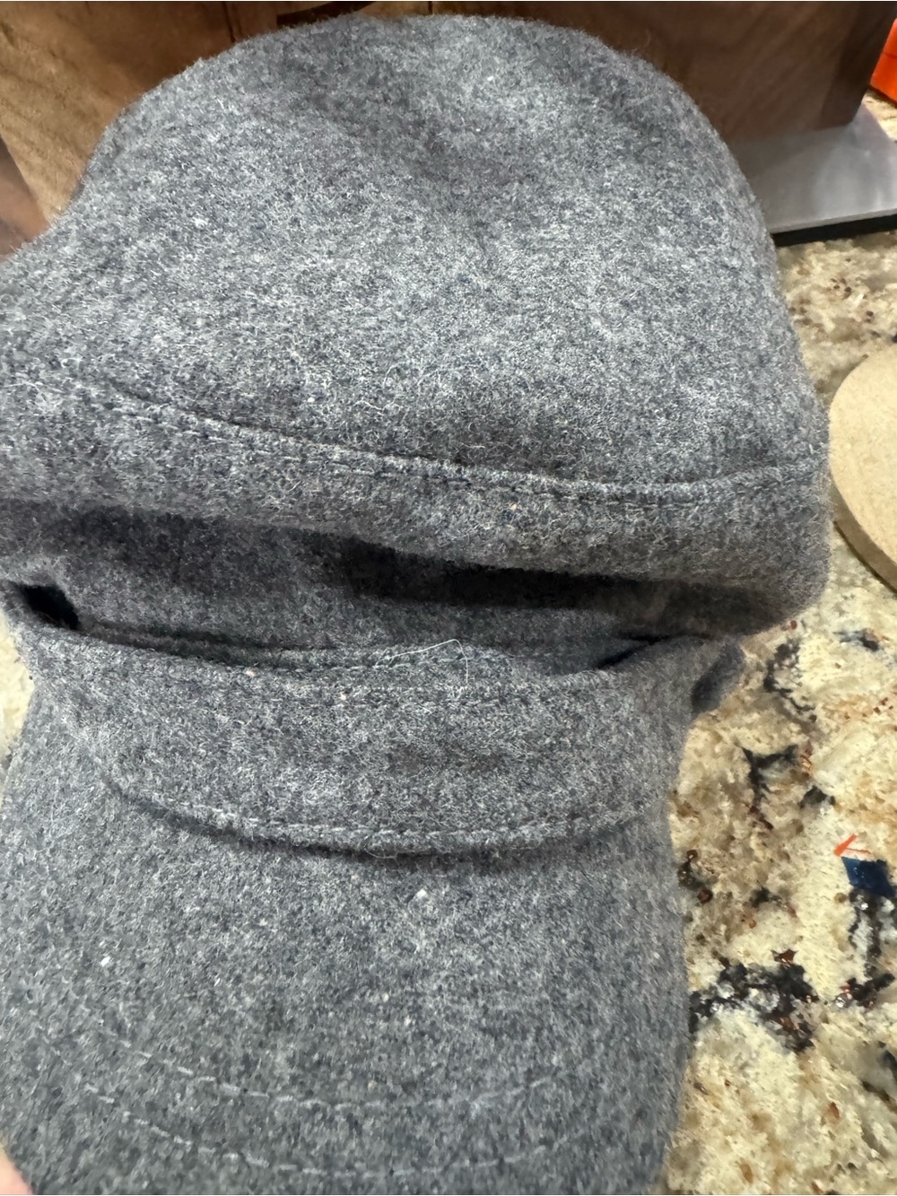 Gray newsboy cap features a felted wool blend material (CL-3)